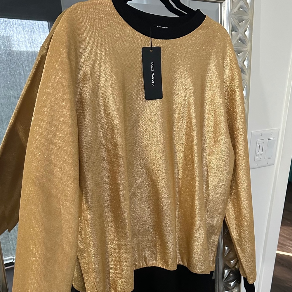 Dolce & Gabbana gold pullover with black trim on sleeves and waistband